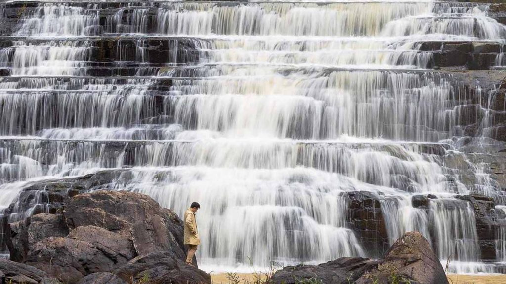 Man standing in front of Pongour Waterfall Da Lat - Things to do in Da Lat