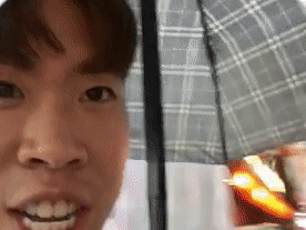Boy under an umbrella in a flood in Ho Chi Minh - Vietnam guide