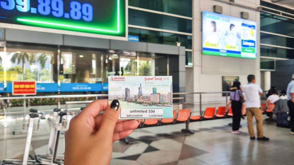 Girl Holding up SIM Card in Tan Son Nhat International Airport in Ho Chi Minh - Ho Chi Minh Itinerary