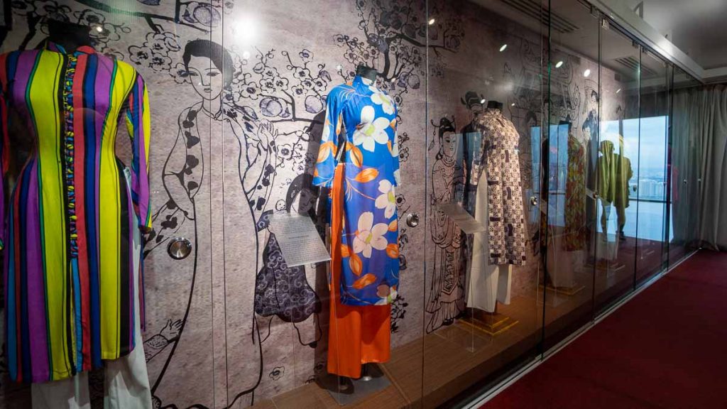 A row of ao dai on display in the ao dai exhibition at saigon skydeck - Things to do in Vietnam