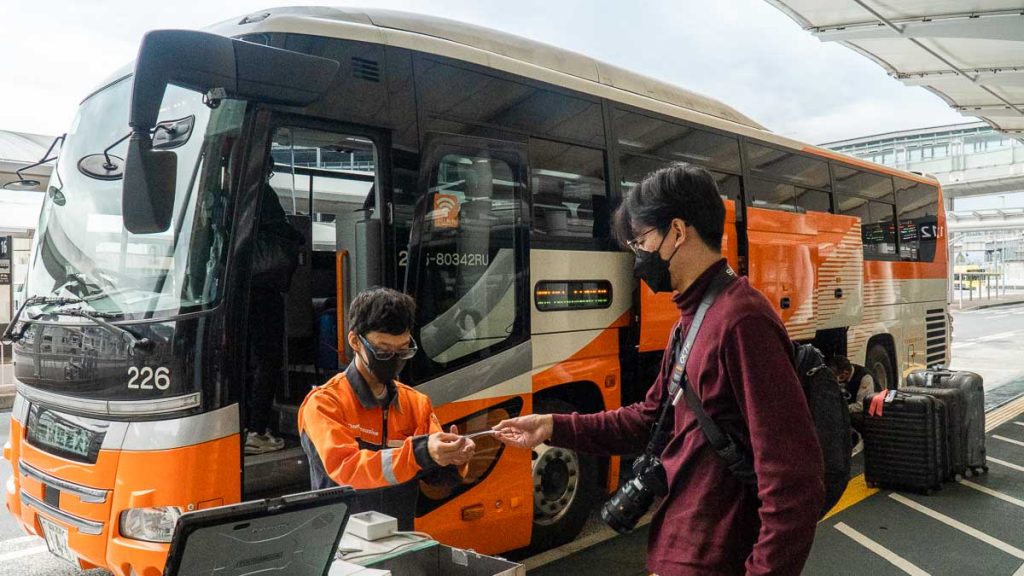 Man checking ticket for Airport Limo Transfer at Narita Airport