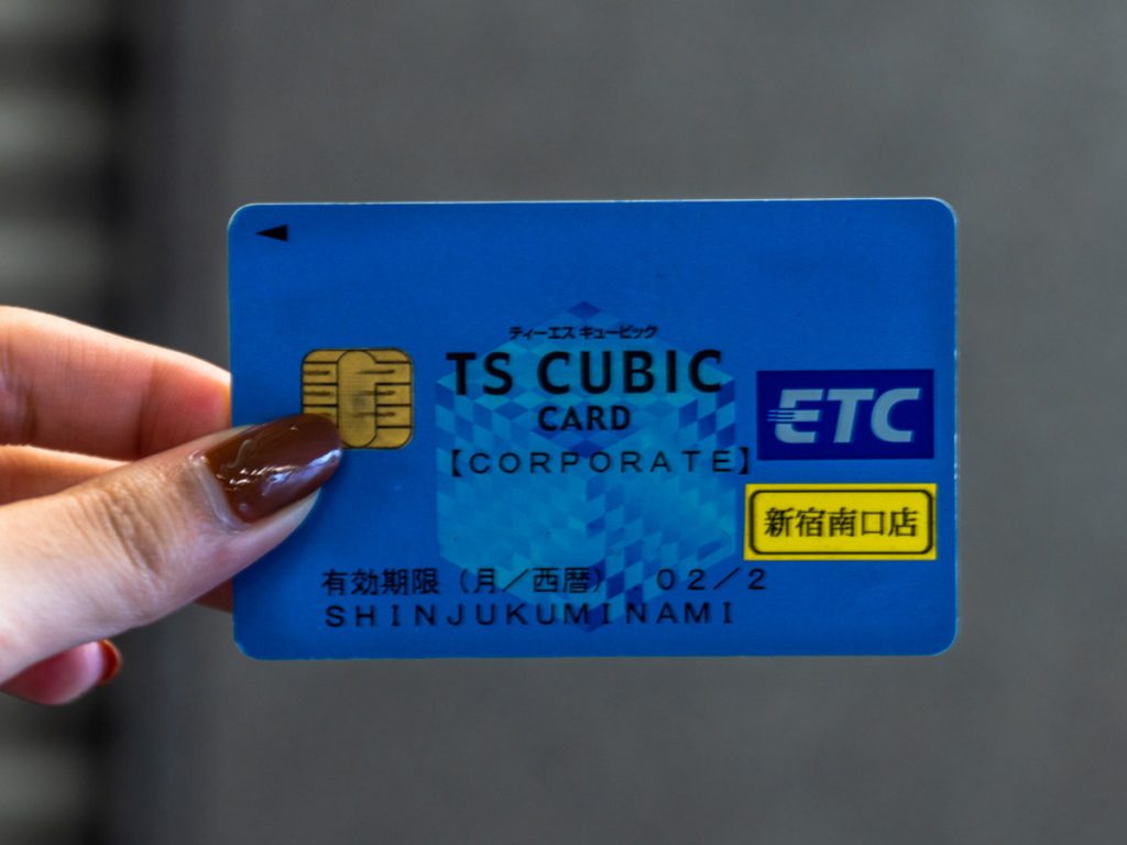 Girl holding ETC card - Japan self-driving guide