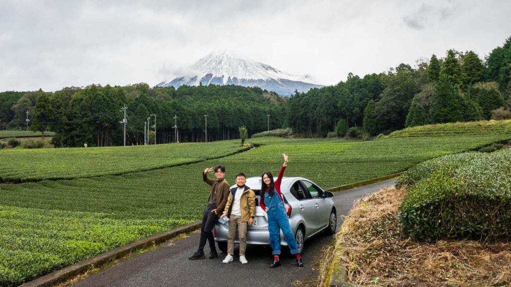 Group of friends standing in front of car in a tea plantation - Mt Fuji viewing spots