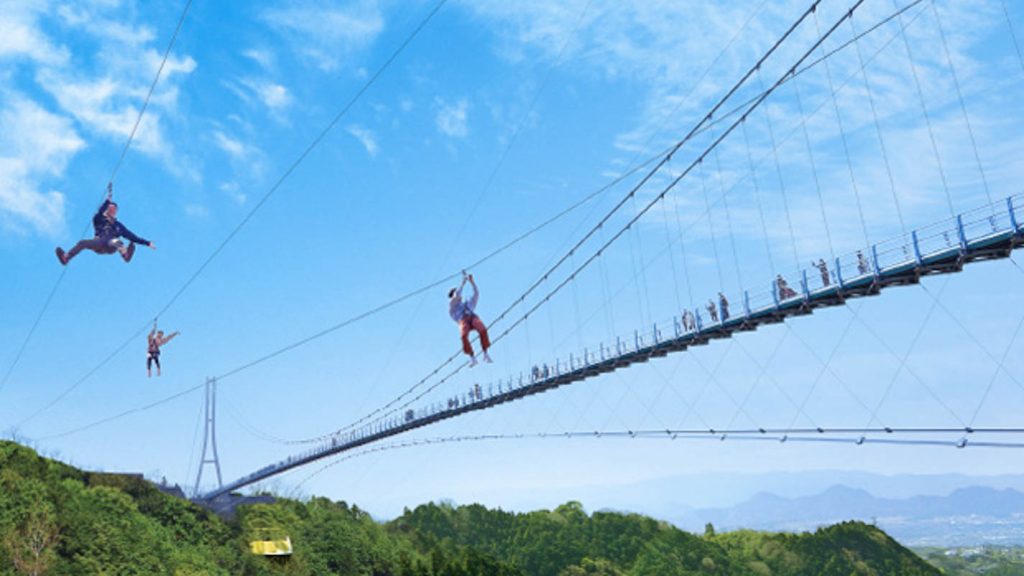 People ziplining beside Mishima Skywalk suspension bridge - Japan Itinerary