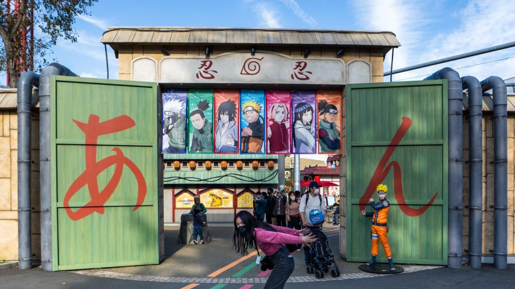 Girl doing the Naruto Run in front of Naruto Village