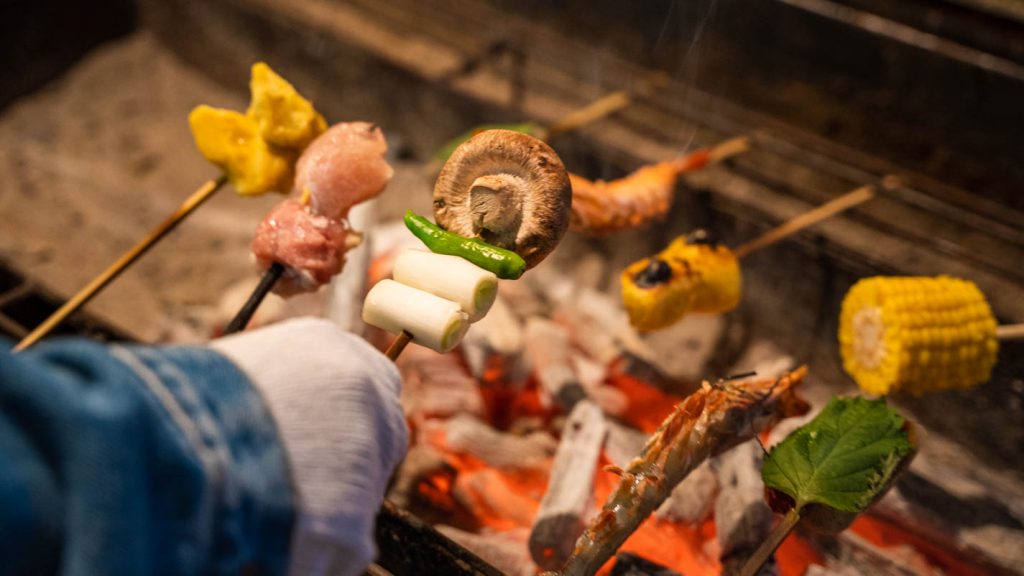 Grilling skewers in Sanrokuen - Mt Fuji Roadtrip