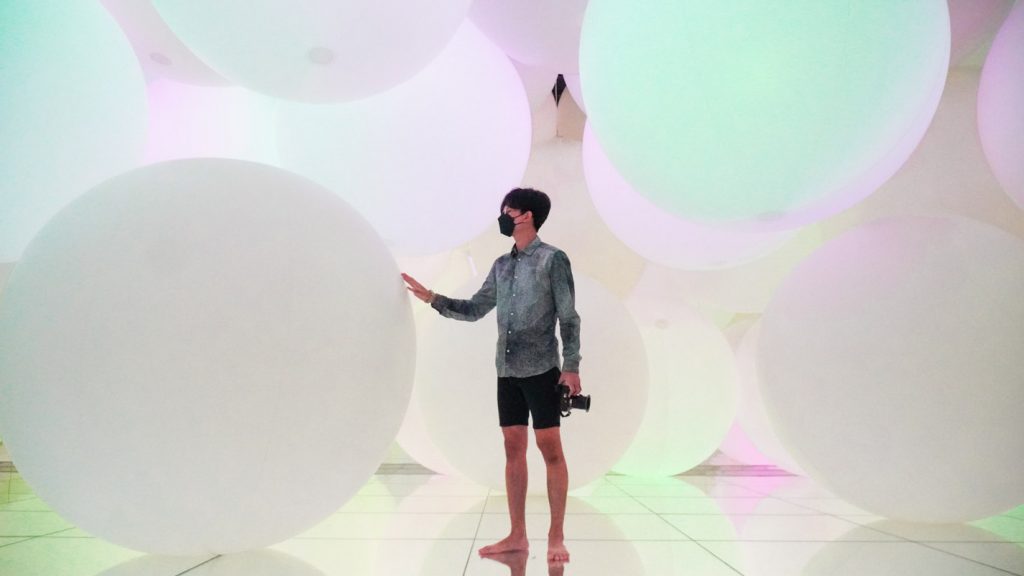 Man pushing inflatable ball at teamLabs Planets Tokyo