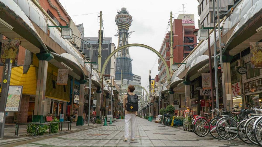 Boy Walking to Tsutenkaku Tower - Things to do in Osaka
