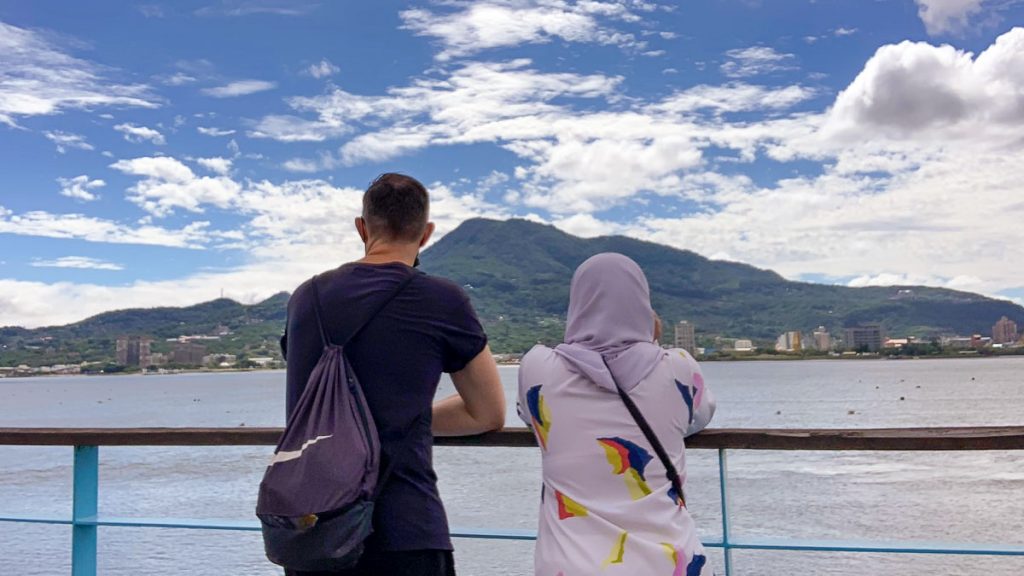 deux personnes regardant vers l'île de bali à tamsui taipei - Solo Traveling in Taiwan For Muslims