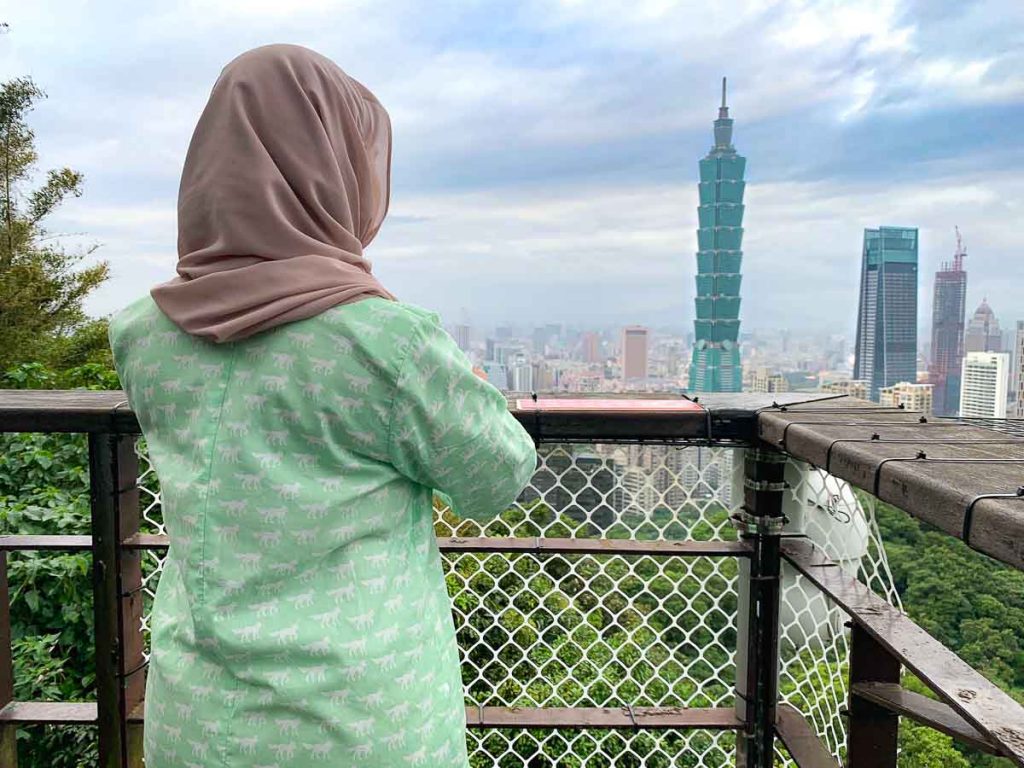 Girl looking out on Elephant Mountain towards Taipei 101 - solo female travel