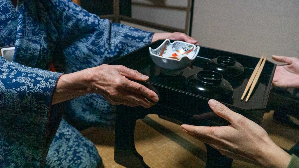 Tray being passed during dinner ceremony - hokuriku guide