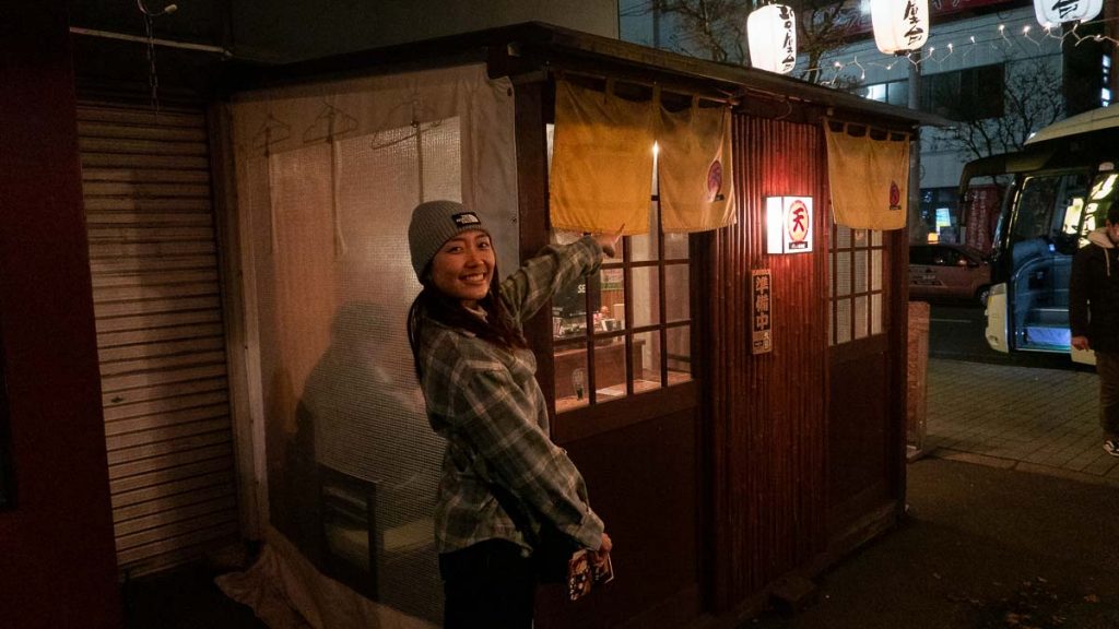 Girl standing in front of food stall at kita no yatai - Hokkaido First-timer Itinerary