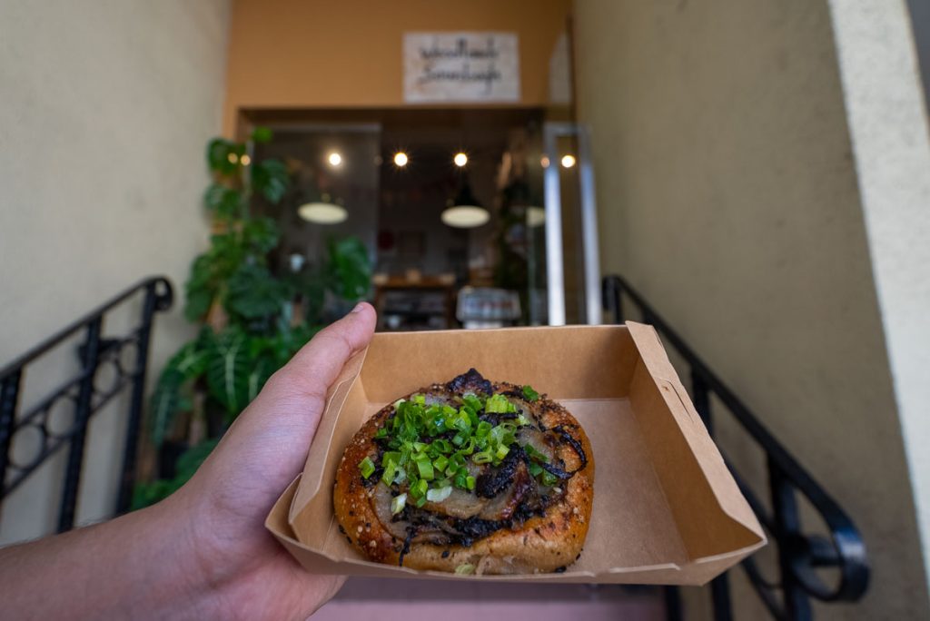 Potato bialy in front of Woodland Sourdough's store front - thomson-east coast line