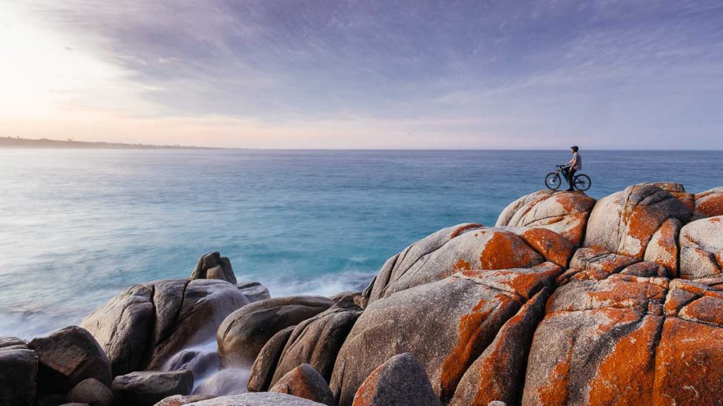 Cyclist at the Bay of Fires - Things to do in Tasmania