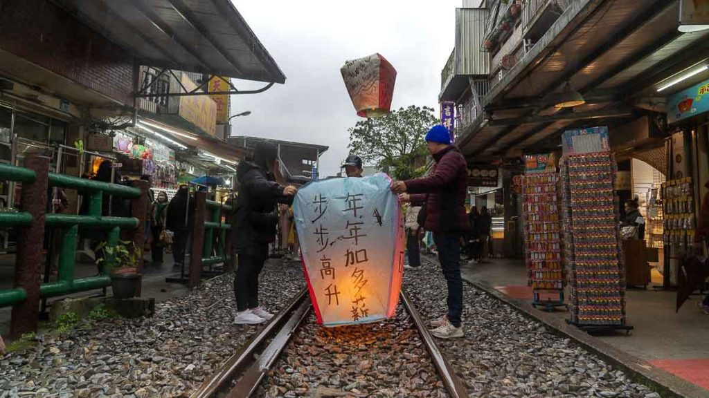 Tourists Release Lantern at Shifen Old Street - Things to do in Taiwan