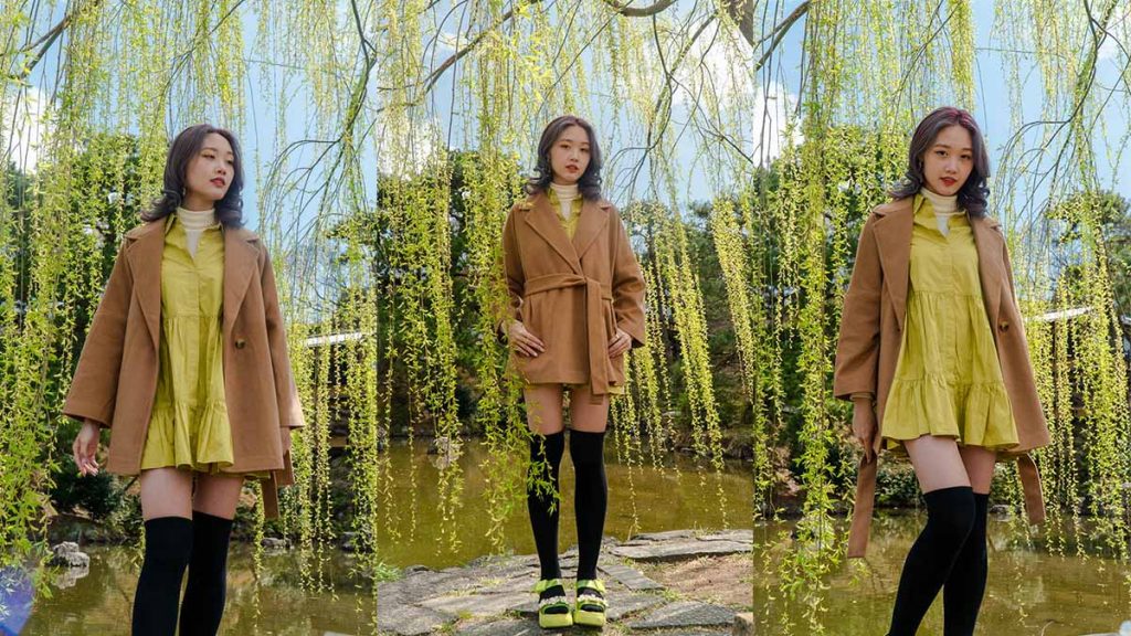 Girl wearing a dress and jacket under a willow tree in Japan - Travel Outfit Ideas