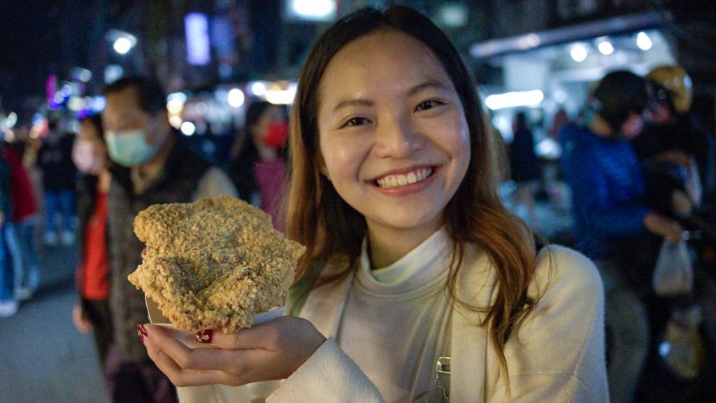 Girl Holding Fried Chicken - Things to eat in Kaohsiung