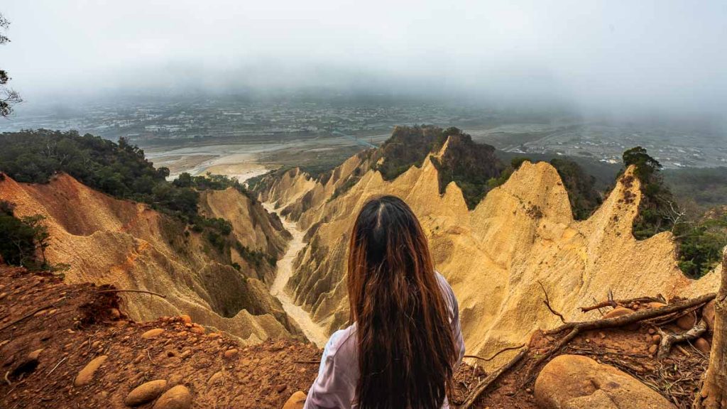 girl looking out from huoyan shan vantage point in - things to do in taiwan