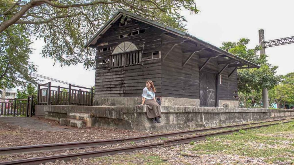 girl sitting at old tai'an railway station - things to do in taiwan