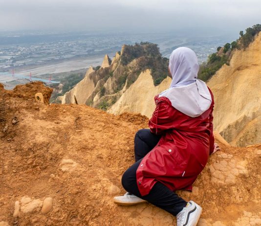 19 Unique Things to Do in Taiwan’s West Coast — Muslim-friendly Guide to Exploring Iconic Spots and Hidden Gems girl sitting at huoyanshan - things to do in taiwan
