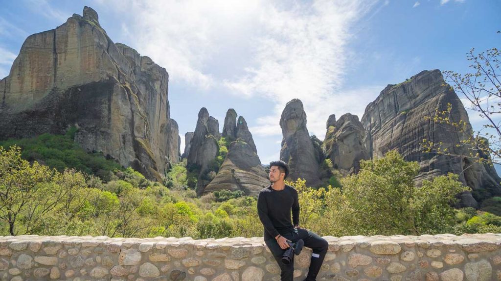 Man Sitting on Meteora Rocks - Things to do in Meteora