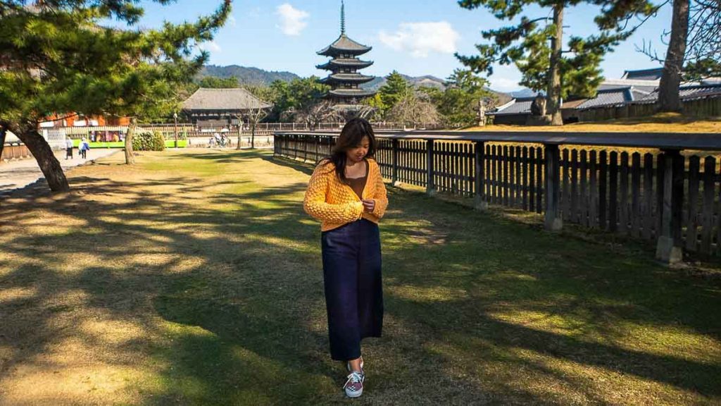 Girl wearing orange cardigan - travel outfit ideas