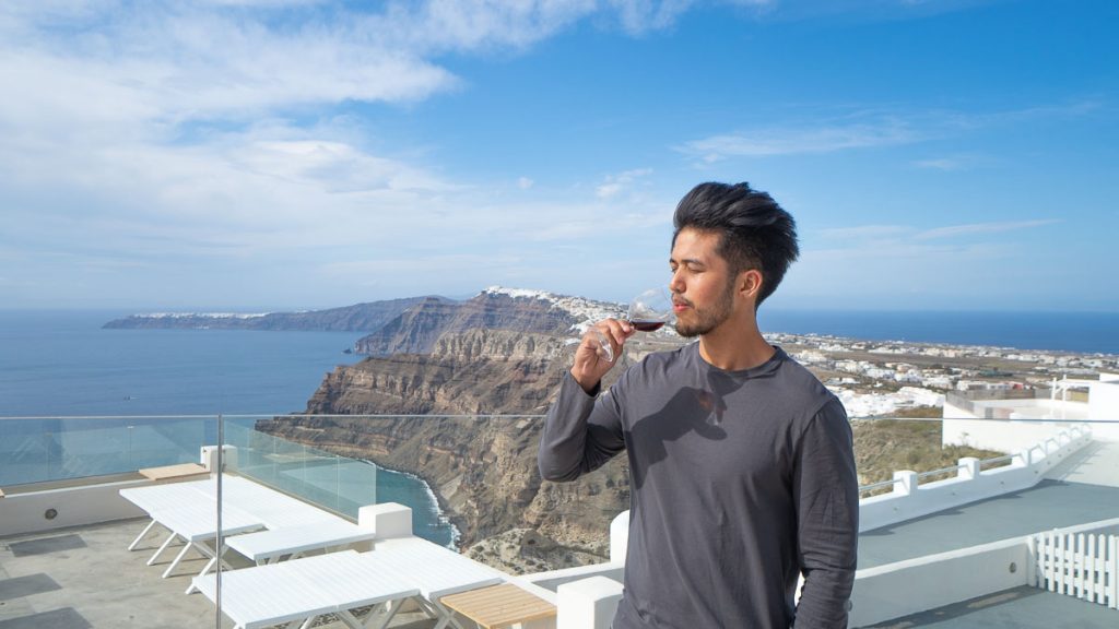 Man Sipping on Wine - Things to do in Santorini