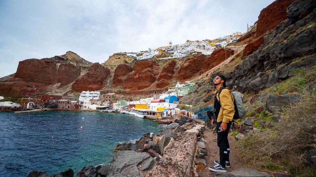 Man looking at the view from Amoudi Bay - Greece Itinerary