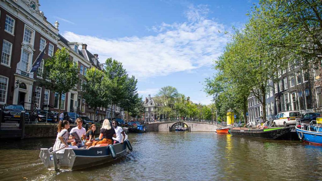 Friends on a Canal Cruise in Amsterdam - Europe Itineraries