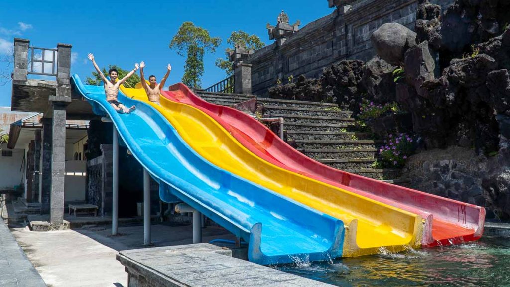 Friends playing children slide at Batur Natural Hot Spring - Things to do in Batur