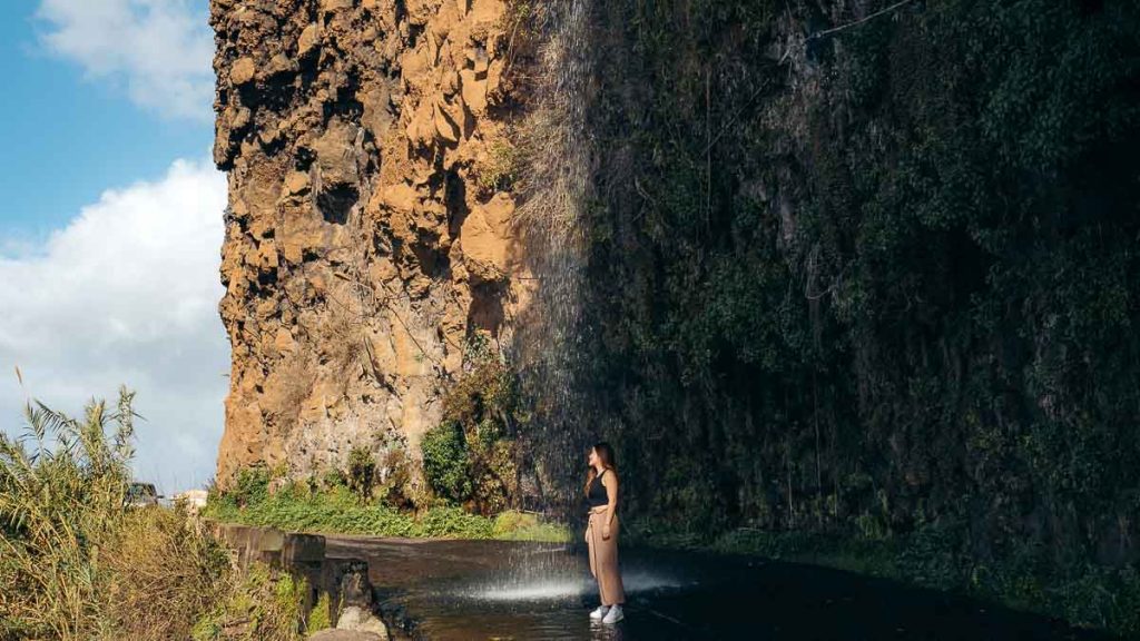 Cascata dos Anjos Waterfall with Visitor - Madeira Travel Guide