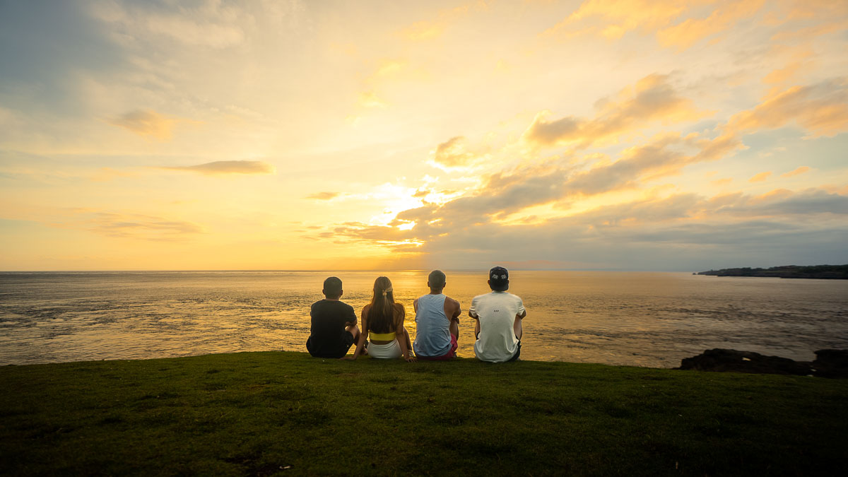 Friends watching the sunset at Smoky Beach - Best places for Sunsets in Bali