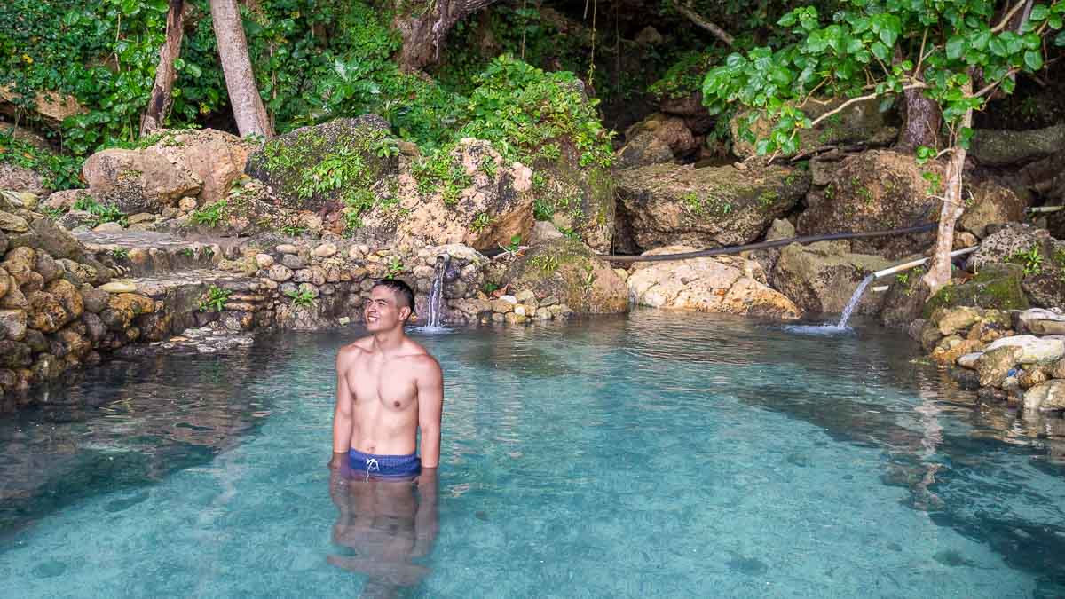 Man swimming in Tembeling Beach and Forest Natural Pool - Bali Itinerary