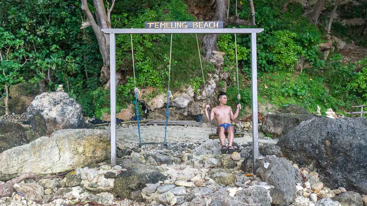 Man on swing at Tembeling Beach and Forest - Bali Itinerary