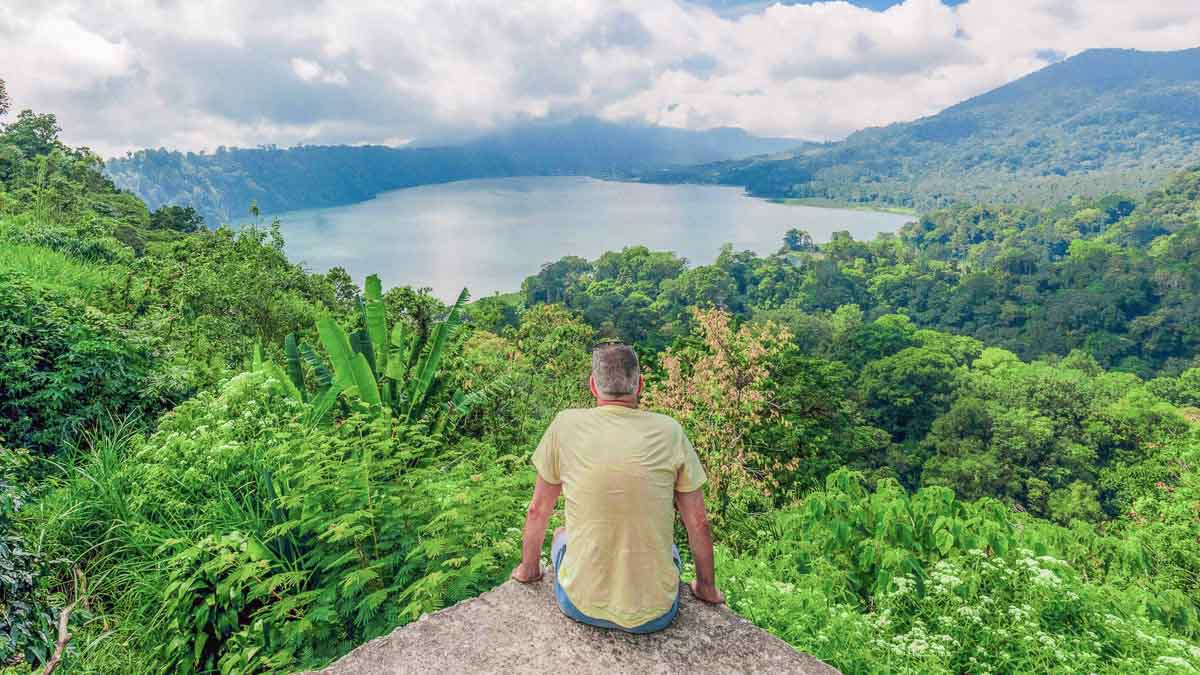 Man seating at viewpoint of Bali Twin Lake