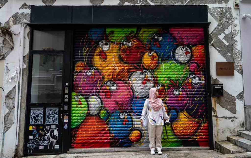 a mural of chickens by Ceet - hong kong itinerary