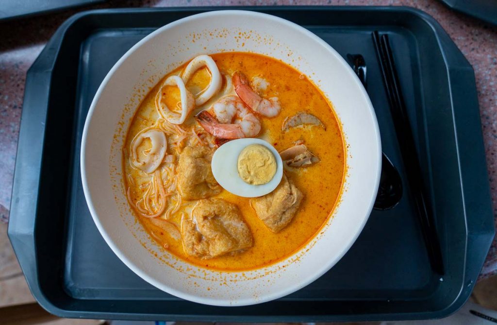 a bowl of seafood laksa served in tahitian terrace - Muslim-friendly attractions in Hong Kong