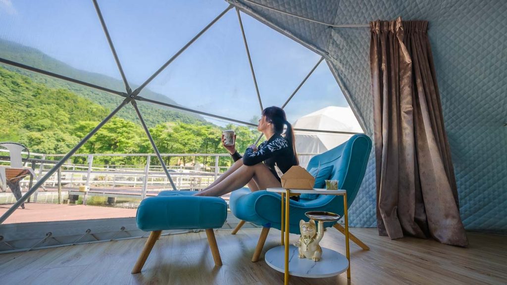 Girl looking at view in dome glamping tent in Hualien - Where to stay in Taiwan