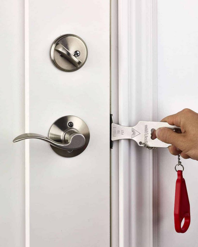 Person Using Portable Door Lock - Travel Essentials