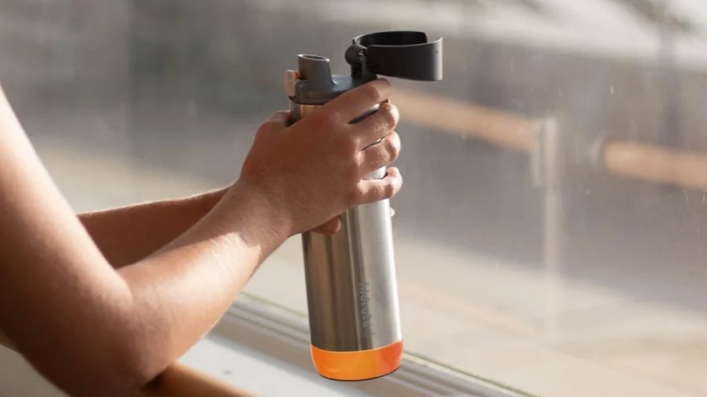 Person Holding Smart Water Bottle - Travel Essentials