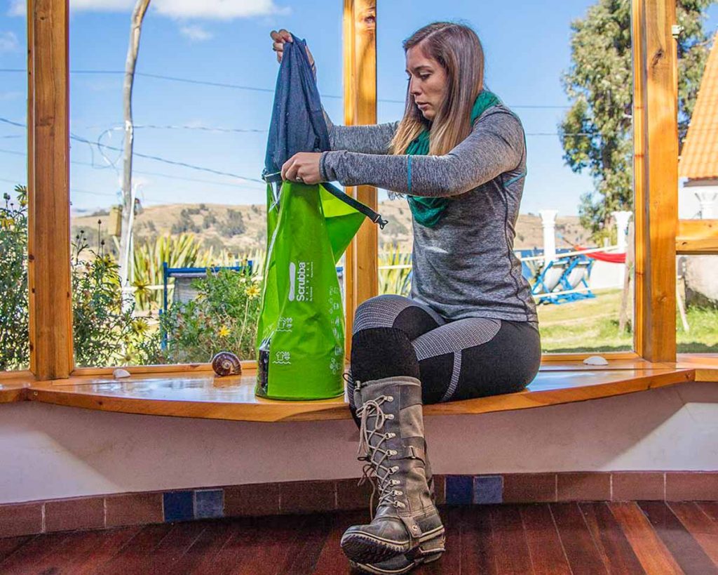 Girl Washing Clothes with Scrubba Wash Bag - Travel Essentials