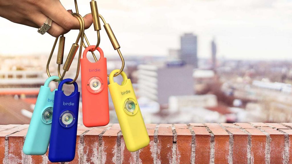 Girl Holding Personal Alarm - Travel Essentials