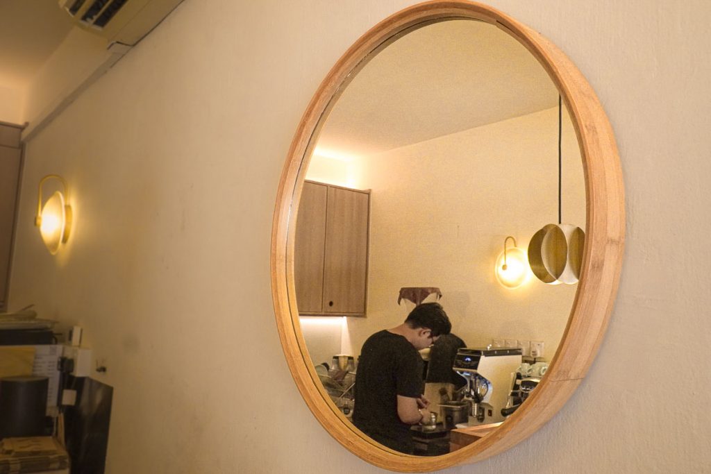 Barista in mirror at Brew & Co.  - Things To Do In Ang Mo Kio