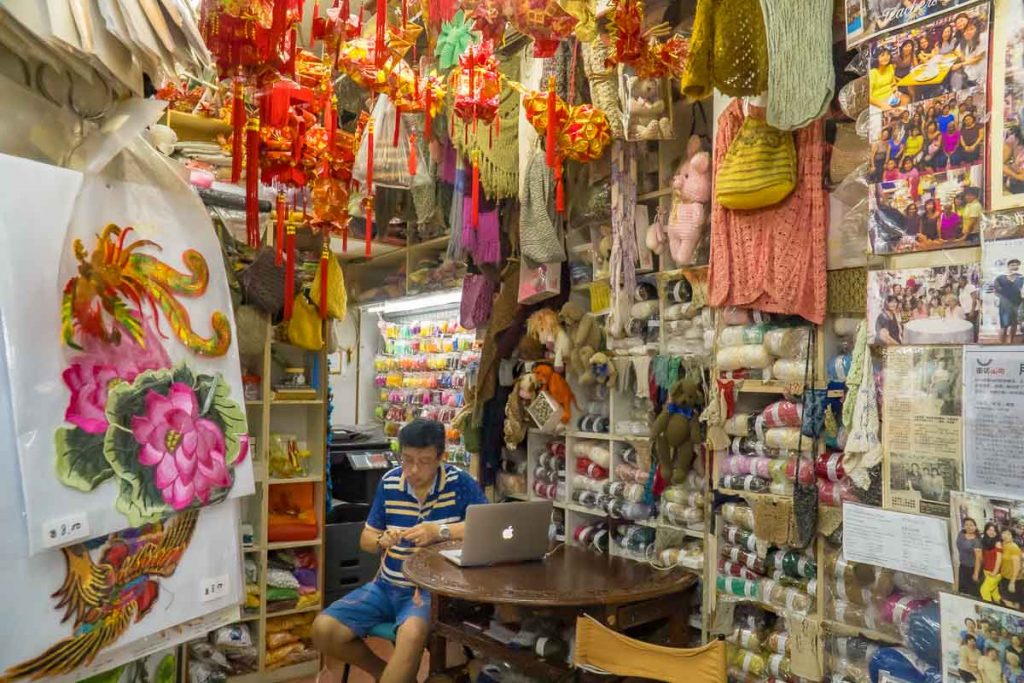 Old man reads newspaper in corner of Elsie Departmental Store - Things To Do In Ang Mo Kio