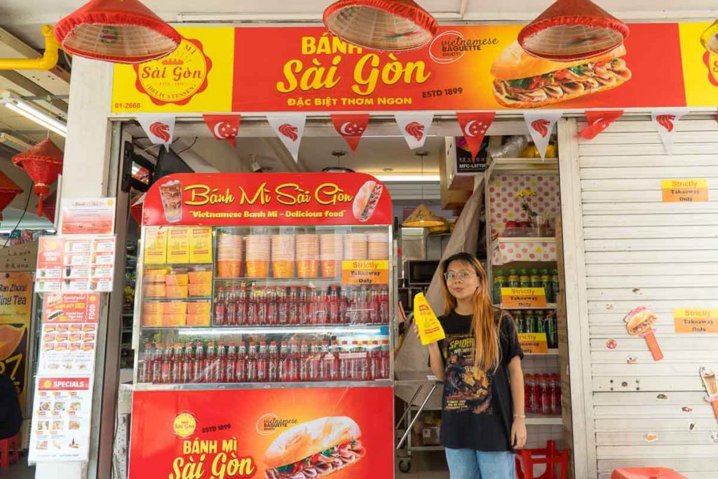 Girl with sandwich at Banh Mi Saigon - Things to do in Singapore