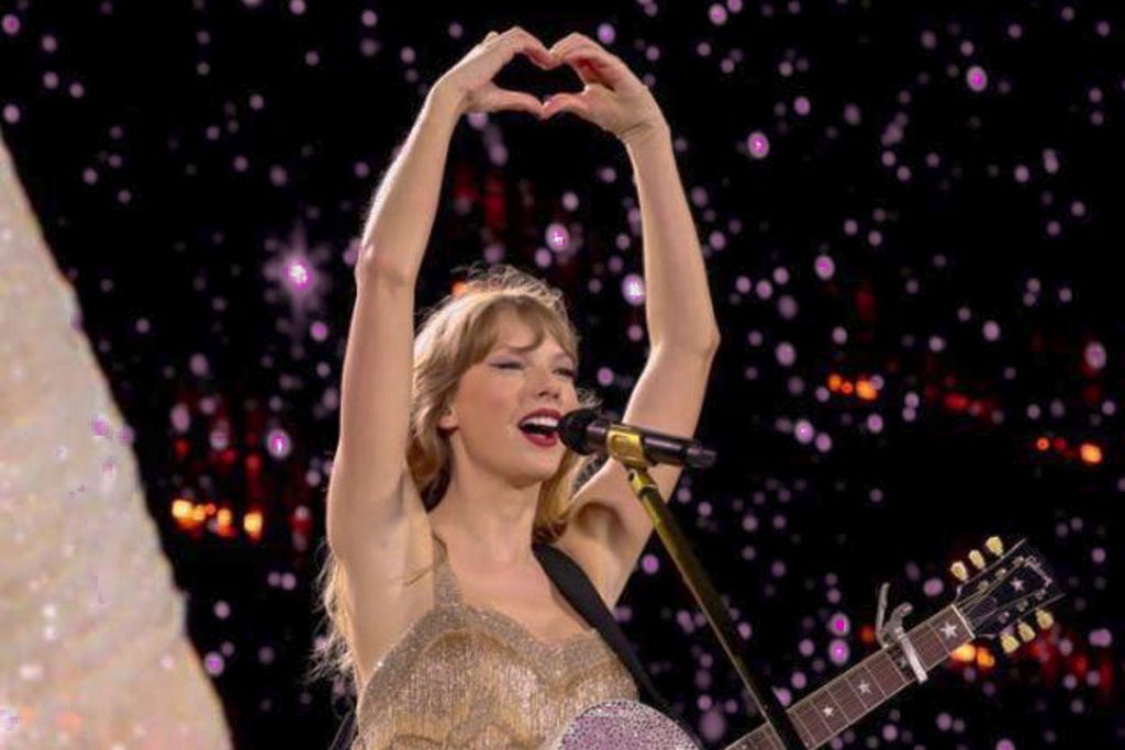 Taylor Swift making a heart at Eras Tour concert - Things To Do In Singapore