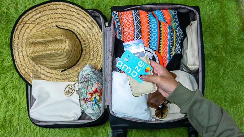 Traveller packing luggage with credit cards and amaze card Lesser Known Travel Credit Card Hacks