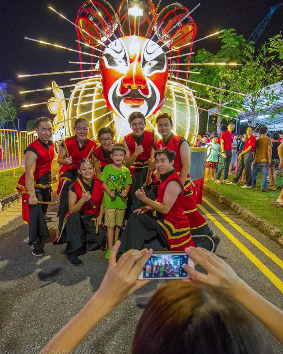 Performers with a spectator at the Chingay Parade 2024