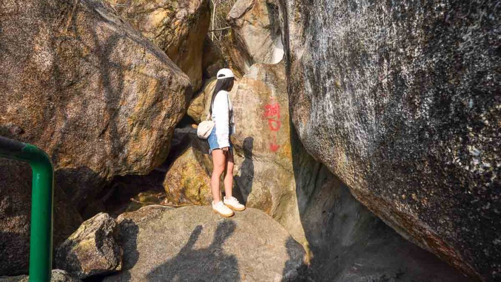 Lady standing at the opening of the Cheung Po Tsai Cave - Hong Kong Itinerary
