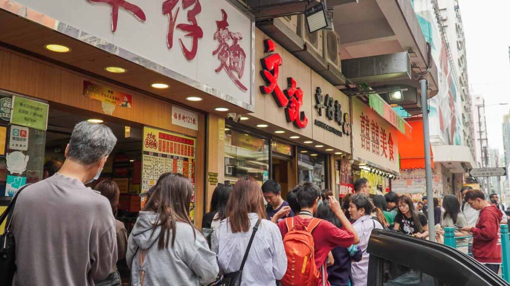 Exterior of Man Kee Cart Noodles, where there is a long queue.